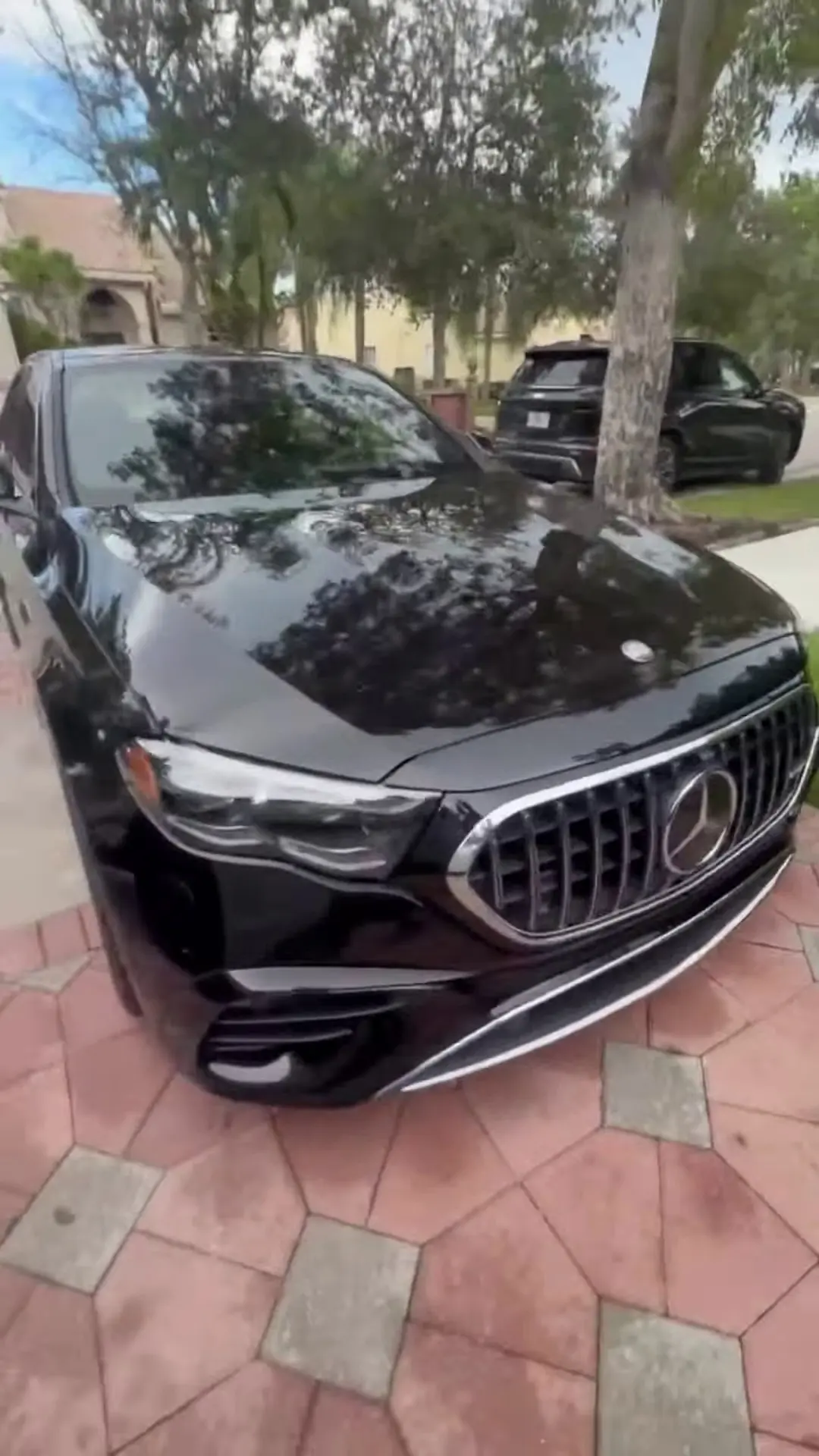 Front of a black Mercedes-AMG with a glossy hood after a detail
